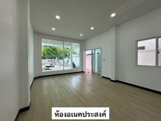 Spacious living room with wooden flooring and large windows