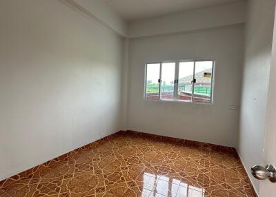 Empty bedroom with tiled flooring and window