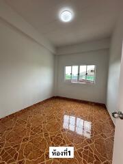 Empty bedroom with tiled flooring and window