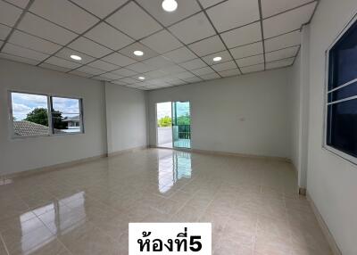 Spacious living area with large windows and balcony access