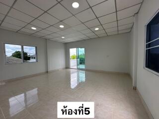 Spacious living area with large windows and balcony access