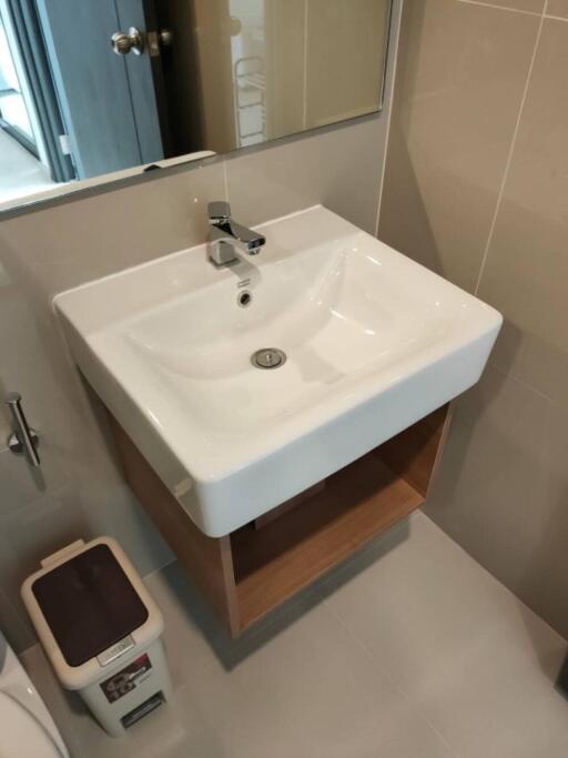 Modern bathroom with white sink and beige tiles