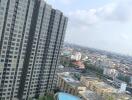 High-rise apartment building with a view of a swimming pool and cityscape