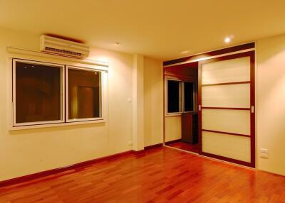 Living room with hardwood flooring and windowed wall