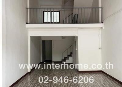 Spacious living room with a loft area and patterned tile flooring