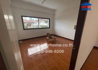 Unfurnished living room with tiled floor and large window