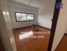 Unfurnished living room with tiled floor and large window