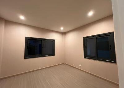 Empty bedroom with windows and ceiling lights