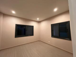 Empty bedroom with windows and ceiling lights