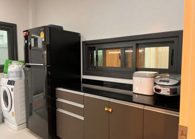 Modern kitchen with black fridge and appliances