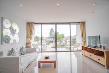 Spacious living room with large windows and modern furnishings