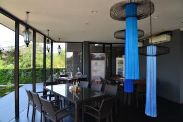 Modern dining area with glass tables and unique hanging decorations