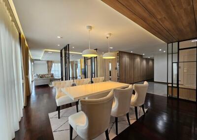 Modern dining area with adjacent living room