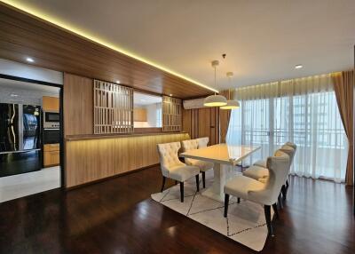 Modern dining area with elegant lighting and wooden accents