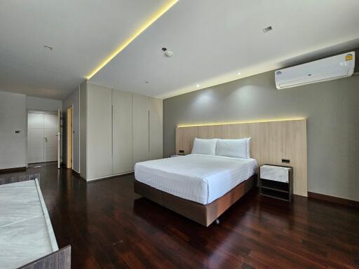 Spacious modern bedroom with a large bed and minimalistic design