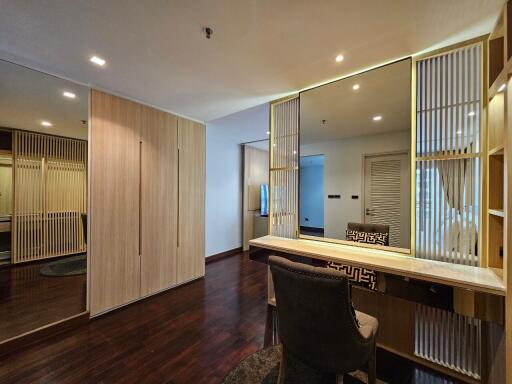 spacious bedroom with built-in wardrobe and vanity area