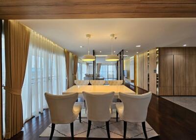 Modern dining room with wooden accents and large windows