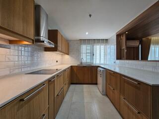 Modern kitchen with wooden cabinets and white countertop