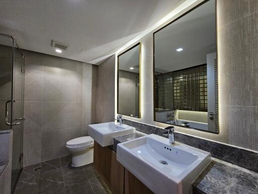 Modern bathroom with dual sinks and large mirrors
