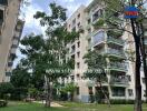 Exterior view of an apartment building with greenery