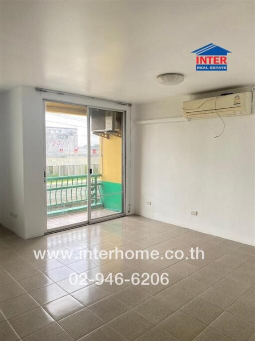 Living room with tiled floor and sliding glass door