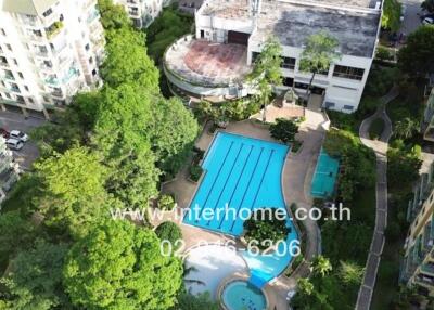 Aerial view of a residential complex with a large swimming pool