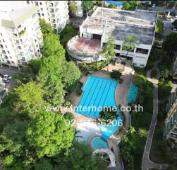 Aerial view of a residential complex with a large swimming pool