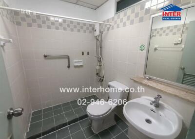 Bathroom with green tiled floor and white fixtures
