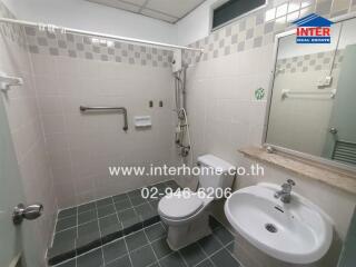 Bathroom with green tiled floor and white fixtures