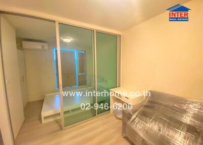 Bedroom with furniture, sliding glass door, and window light