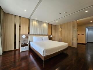 modern bedroom with wooden floor and wall paneling