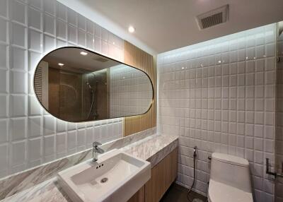 Modern bathroom with marble countertop and stylish mirror