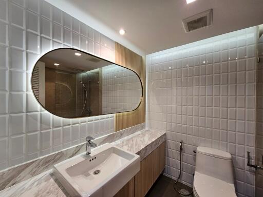 Modern bathroom with marble countertop and stylish mirror