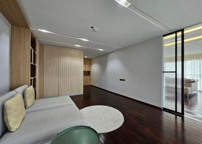 Modern living room with wooden flooring and large windows