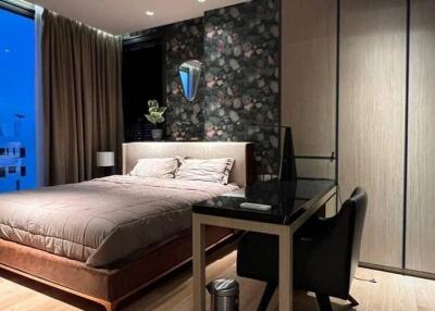 Modern bedroom with large windows, double bed, and wardrobe
