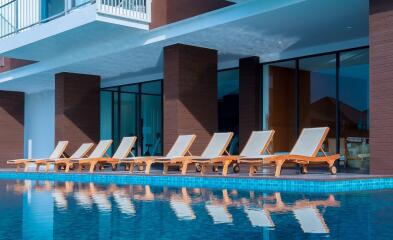 Outdoor pool area with lounge chairs