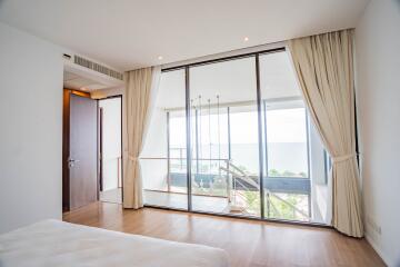 Modern bedroom with large windows and balcony view