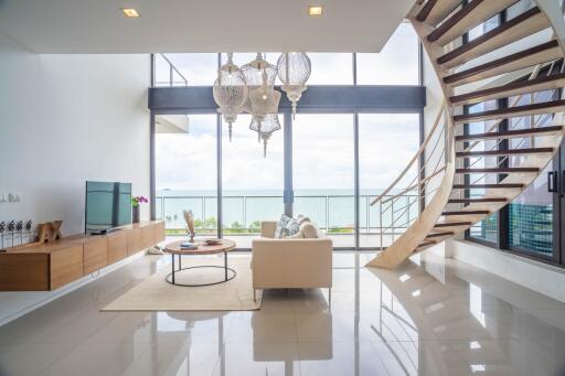 Spacious living room with modern decor and ocean view