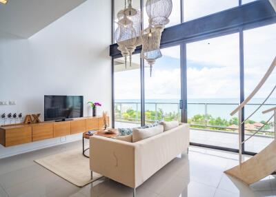 Modern living room with large windows and ocean view