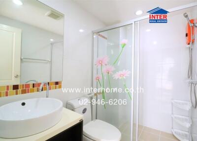 Modern bathroom with glass shower and floral decals