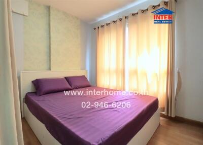 Bright bedroom with double bed and large windows