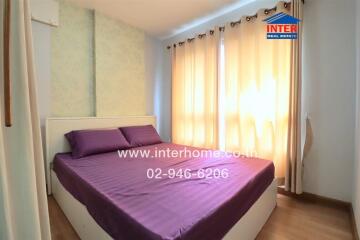 Bright bedroom with double bed and large windows