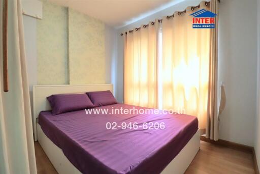 Bright bedroom with double bed and large windows