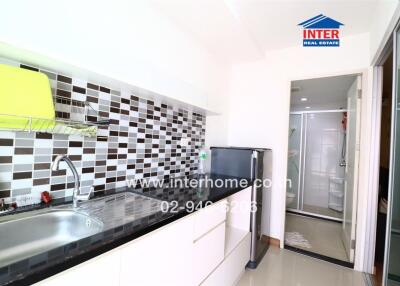 Modern kitchen with tiled backsplash and appliances