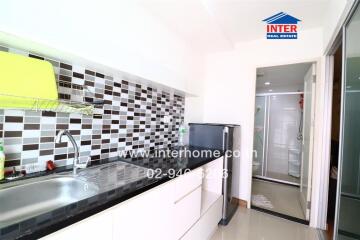 Modern kitchen with tiled backsplash and appliances