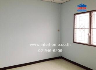 Empty bedroom with window and tiled floor