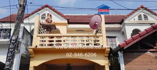 Exterior view of a two-story house with a balcony