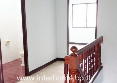 Hallway with wooden stair railing