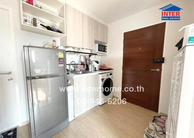 Compact kitchen with appliances and wooden flooring