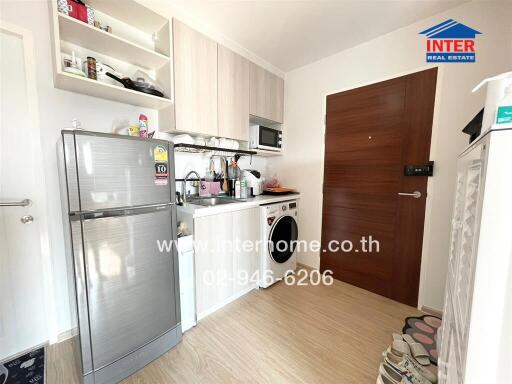 Compact kitchen with appliances and wooden flooring